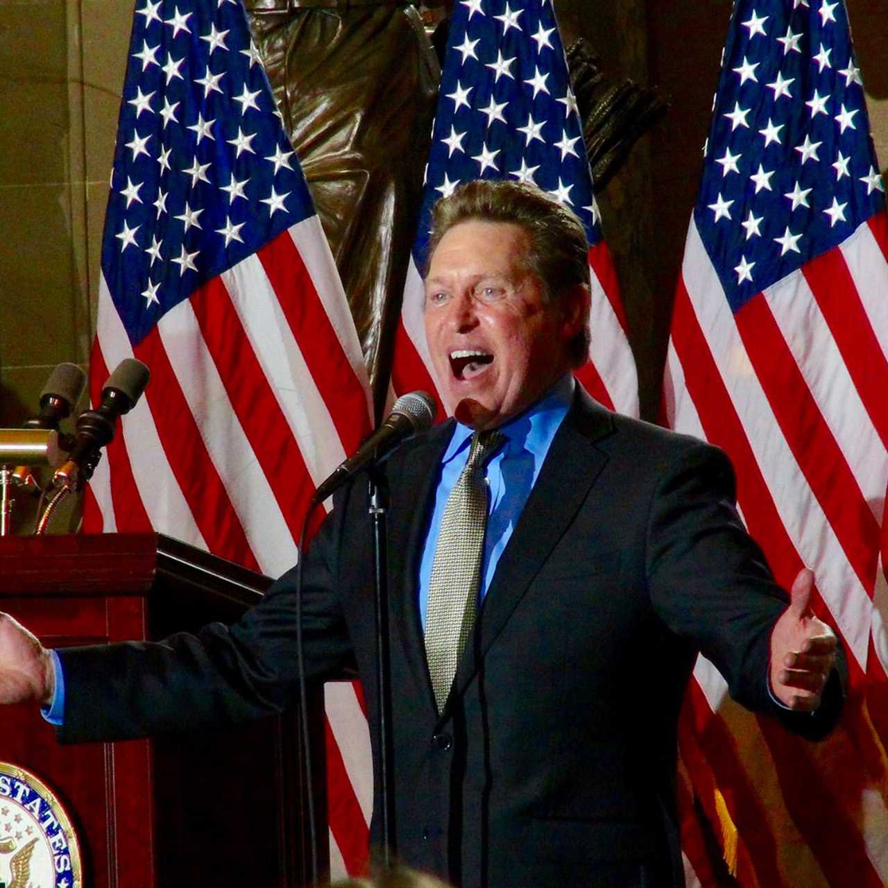 Singing in front of American flags
